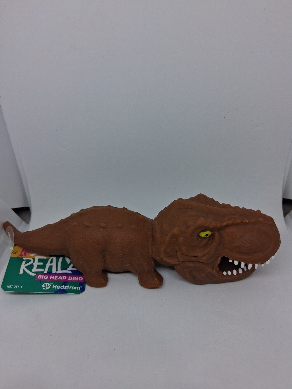 Crunchy Brown Big Head Dino Reptile Squishy Toy with Yellow Eyes